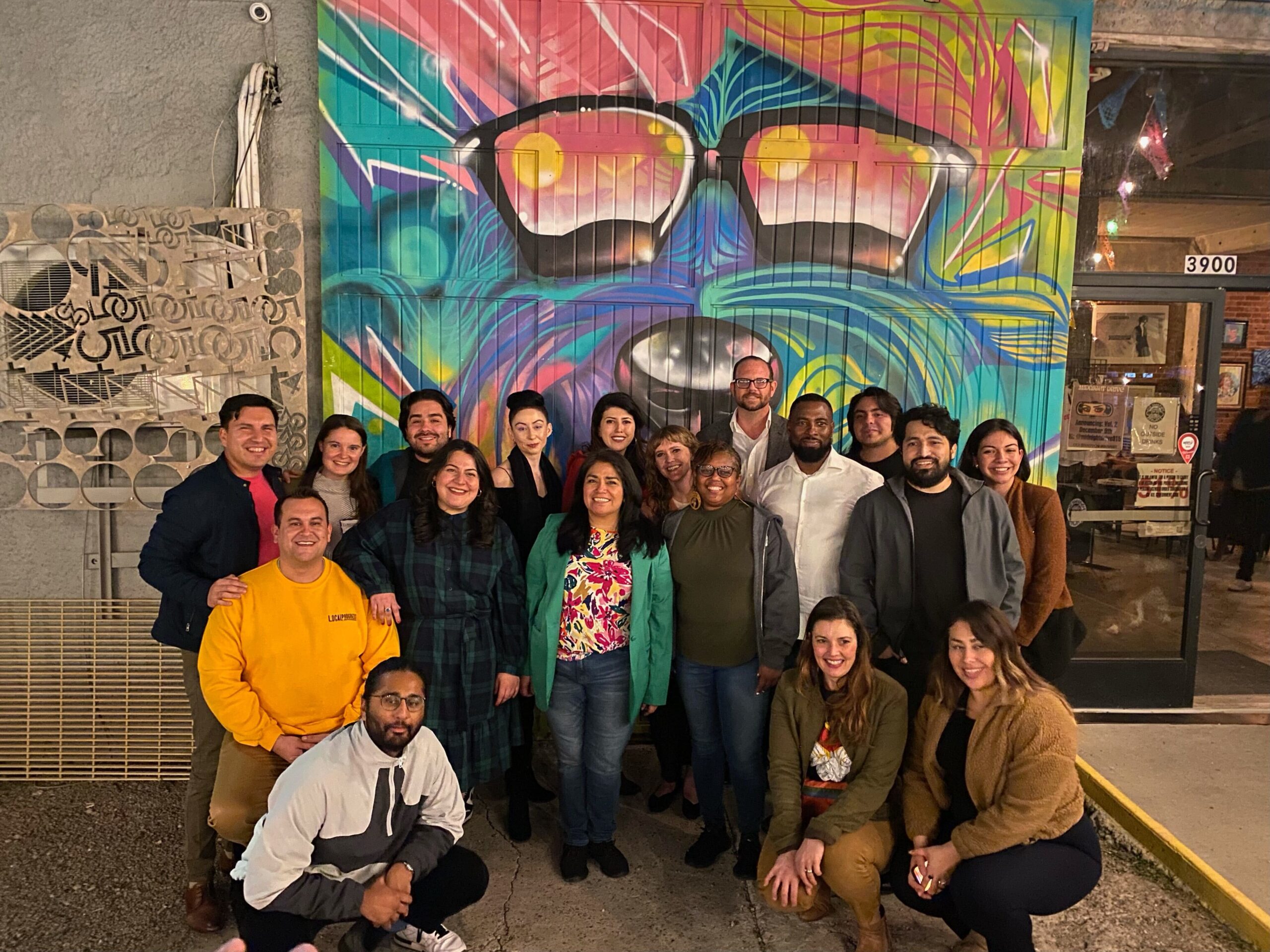 LPTX members and partners posing together in front of a mural in El Paso, Texas.