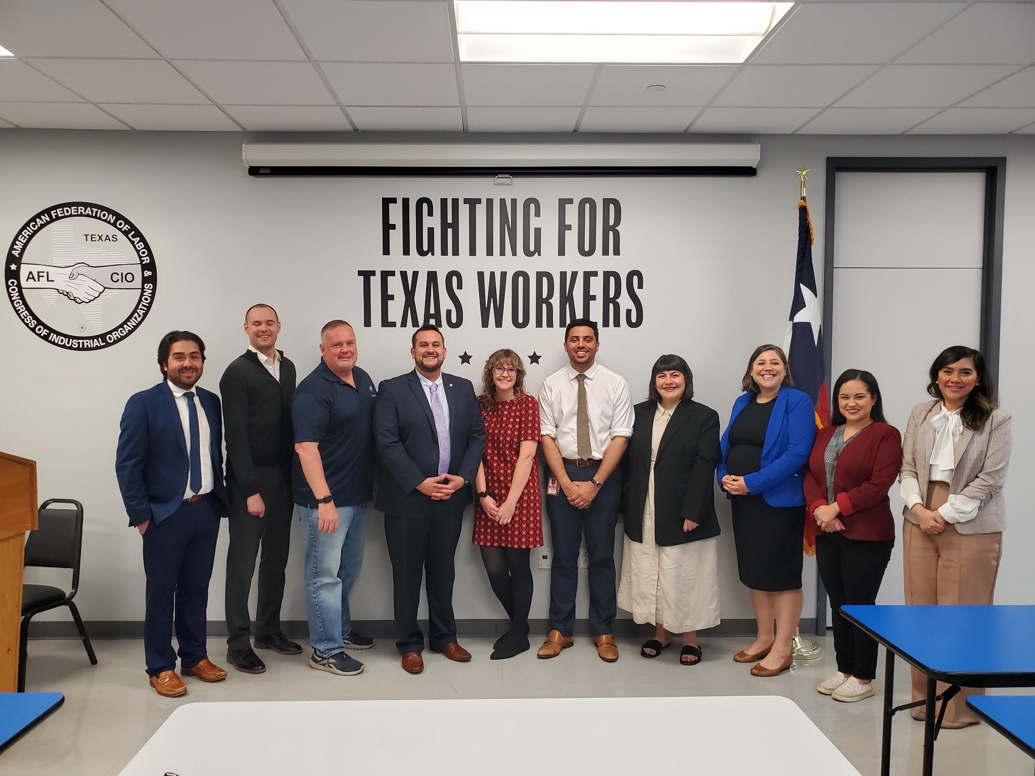 LPTX members, parters, and staff posing for a photo in front of a mural that says "Fighting for Texas Workers" in Austin, Texas.