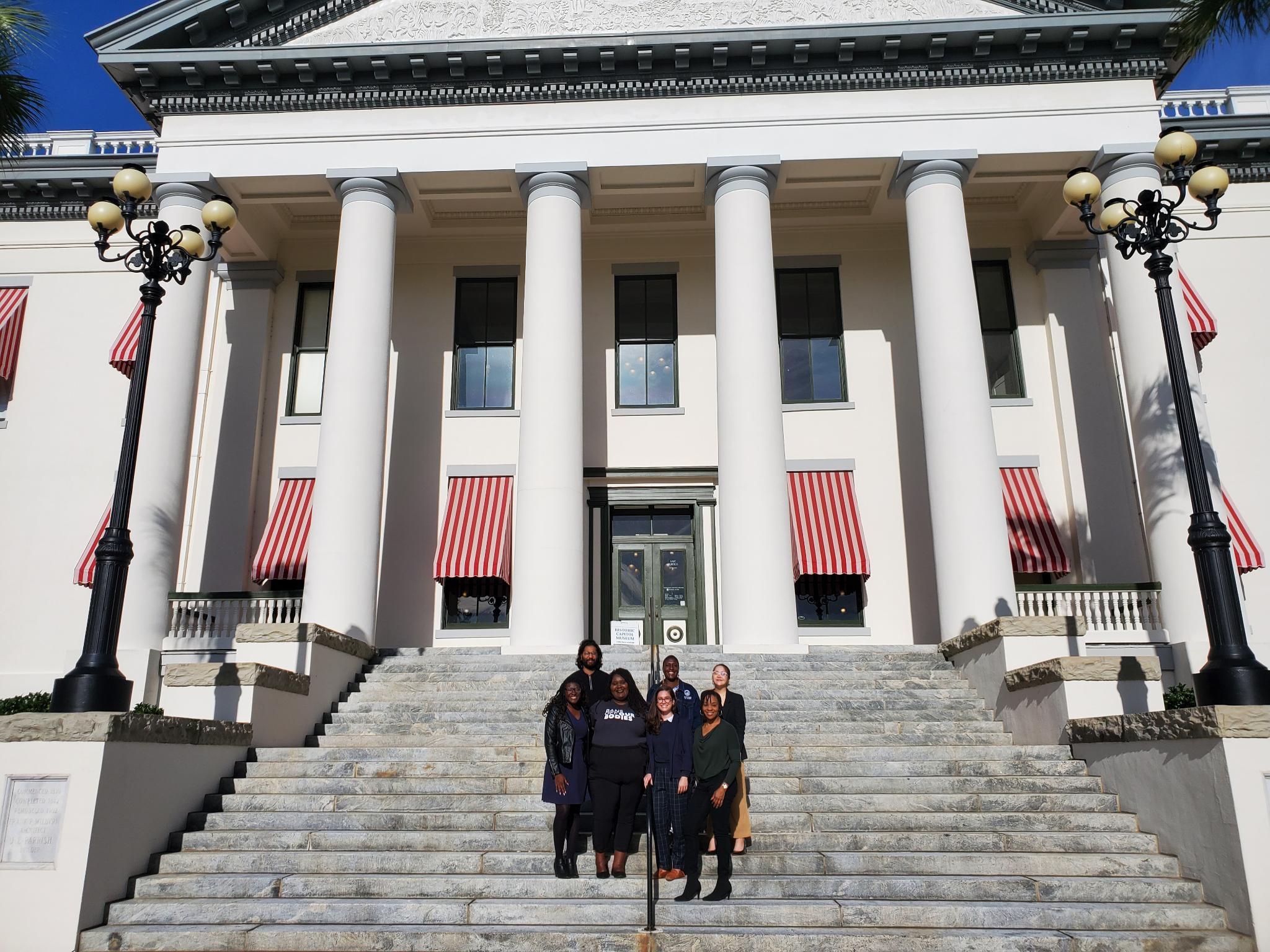 LPFL members and staff posing for a photo in front of the old capitol in Tallahassee.