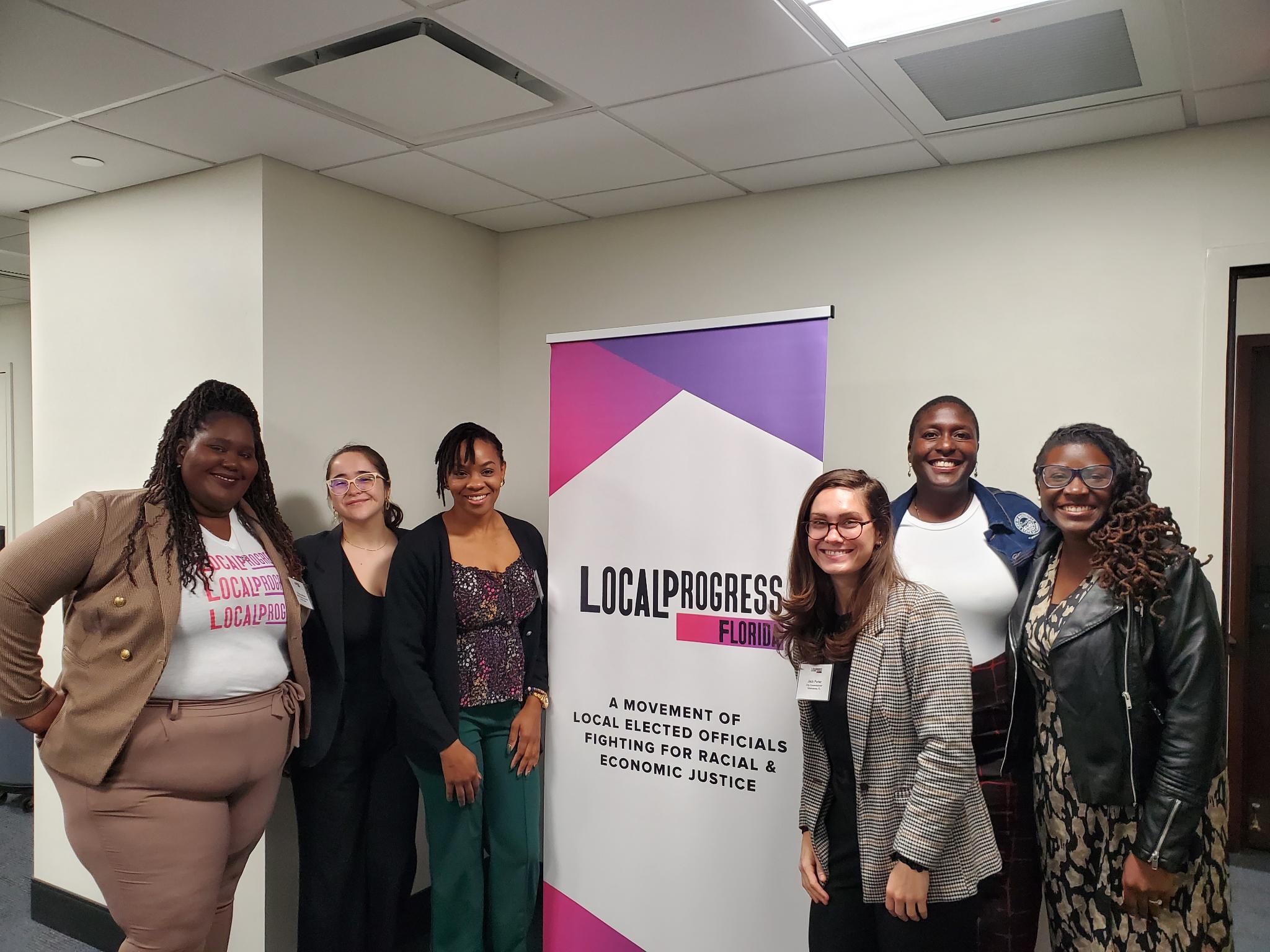 LPFL members and staff posing next to a LPFL sign.