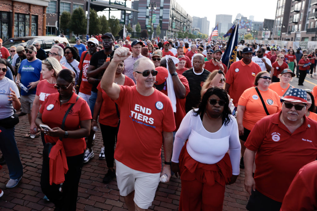 Shawn Fain, president of the United Auto Workers (UAW), center, marches with UAW members and supporters during a Labor Day parade in Detroit, Michigan, US, on Monday, Sept. 4, 2023.