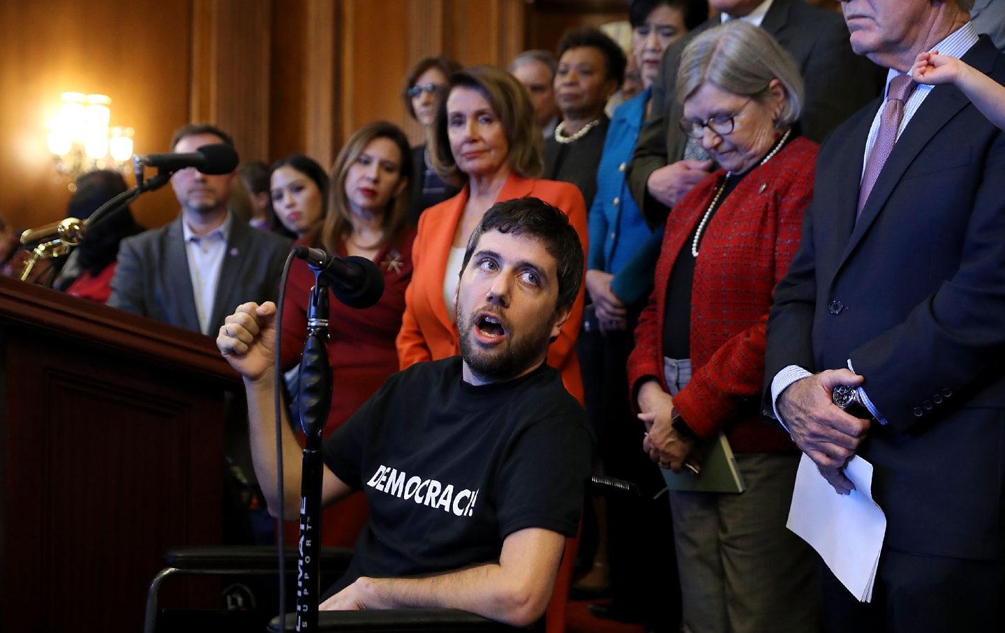 Ady Barkan (C) delivers remarks during a rally organized by House Minority Leader Nancy Pelosi (D-CA) at the U.S. Capitol December 19, 2017. (Chip Somodevilla/Getty Images)