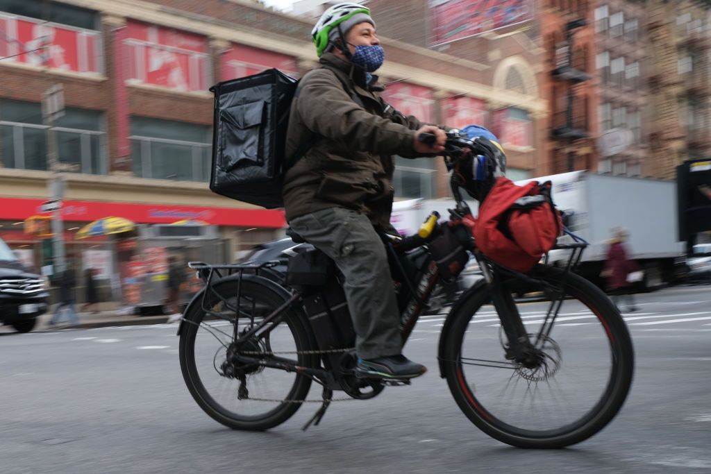 A delivery person rides an electric bike through the streets of Manhattan on Nov. 15, 2022.Photographer: Spencer Platt/Getty Images North America