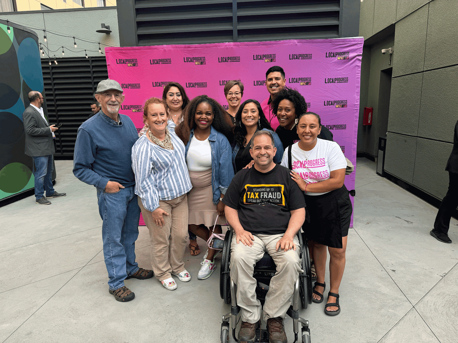 A group of people posing in front of a sign