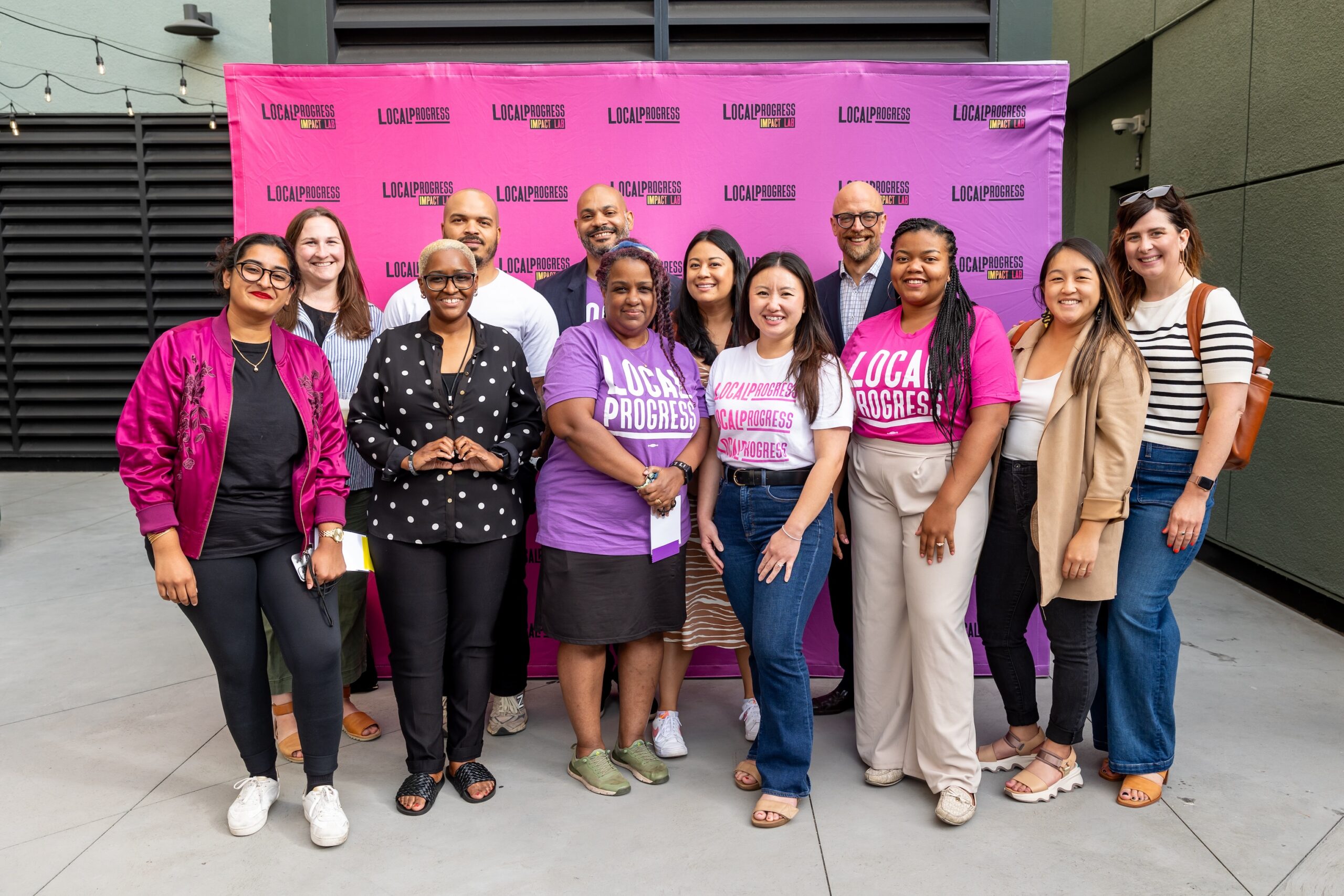 The LPMN delegation at the LP National Convening standing in front of a Local Progress step and repeat.