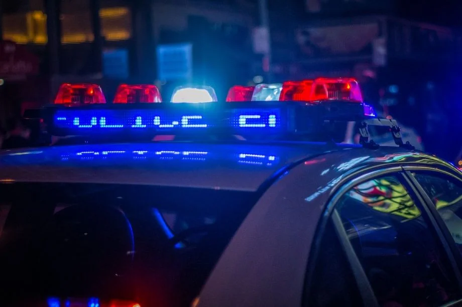 Photograph of police sirens in the dark (Photo by Michael Förtsch / Unsplash)