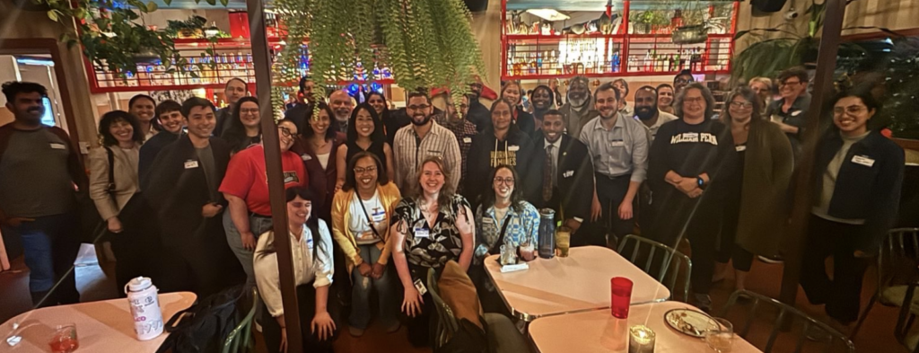 A group of people posing for a picture at a bar