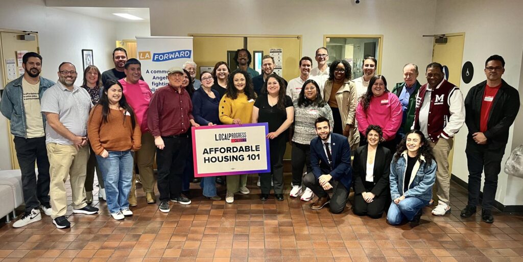 A group of people posing for a picture with a sign that reads "affordable housing 101"