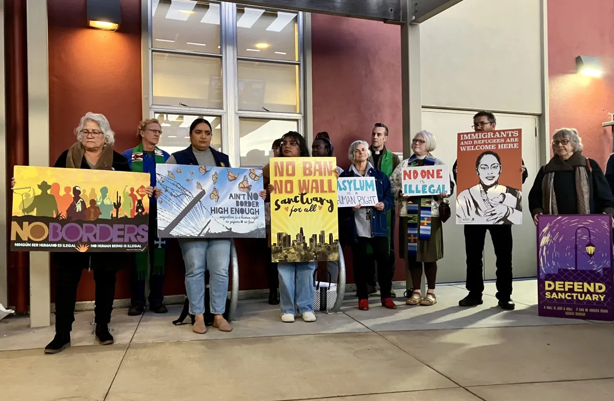 Migrant advocates and members of community organizations in the East Bay hold up signs in support of Berkeley’s sanctuary city status ahead of Tuesday’s council meeting. Credit: Vanessa Arredondo