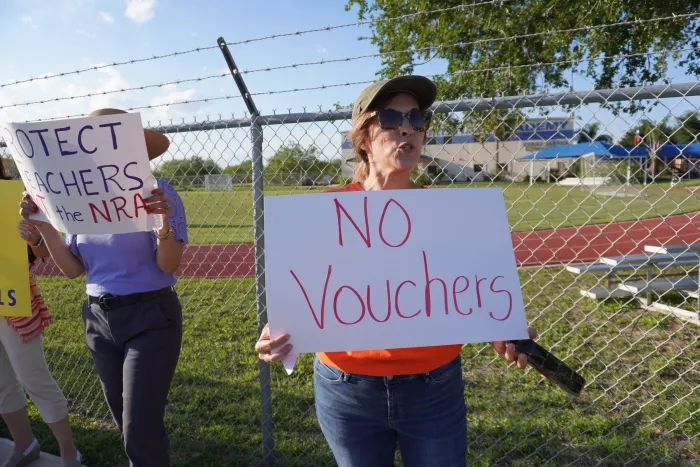 Participants in a community protest with McAllen AFT and other allies outside one of Gov. Abbott’s pro-voucher campaign stops in 2023. Photo by Clarissa Riojas.