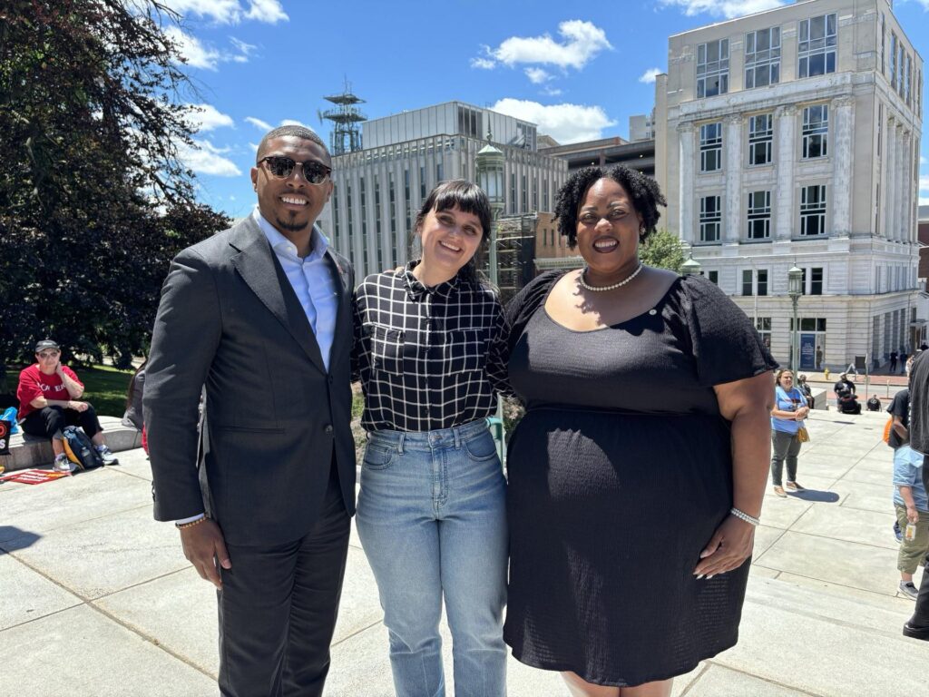 A group of three people posing for a photo