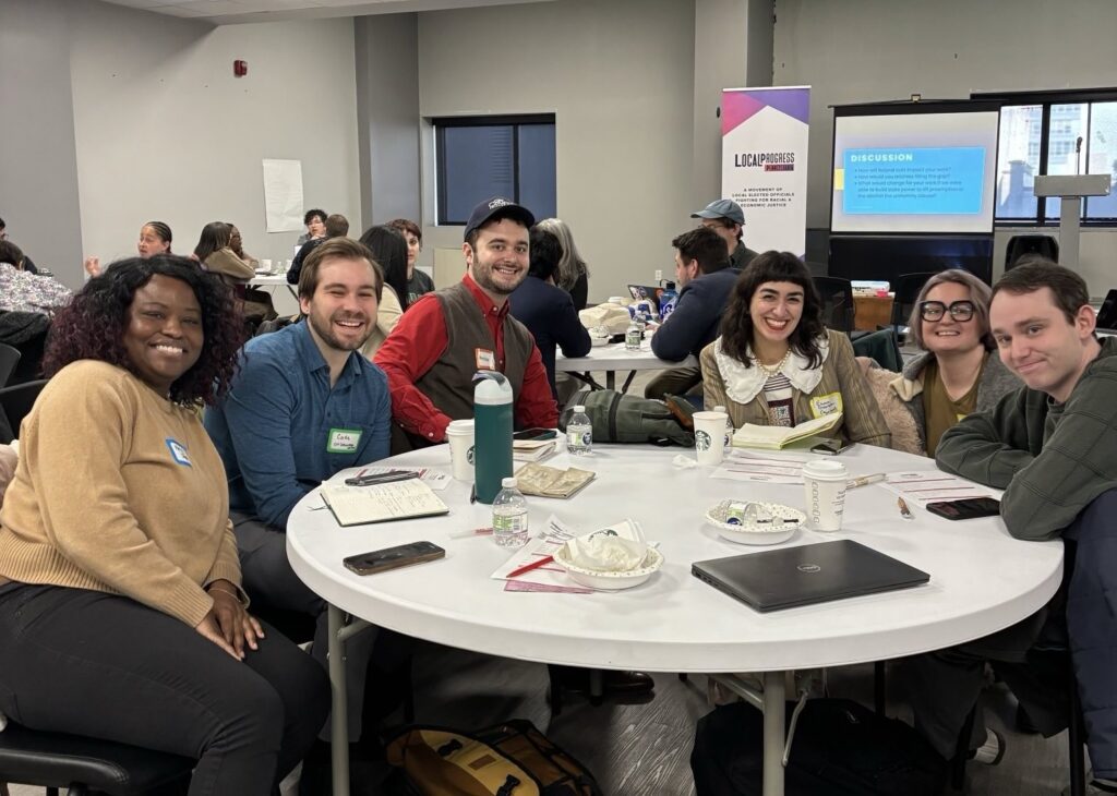 A group of people smiling at a table