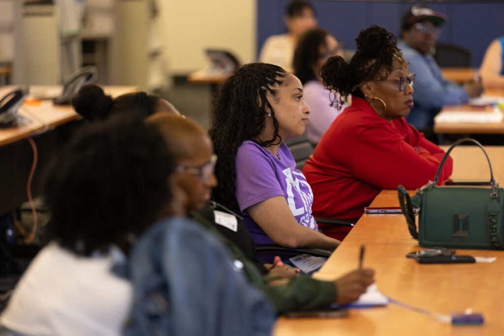 Group of people at a desk listen