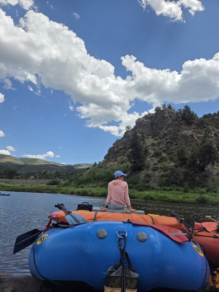 A picture of someone perched on top on a raft