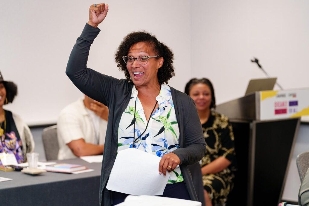 A women holding her fist up smiling