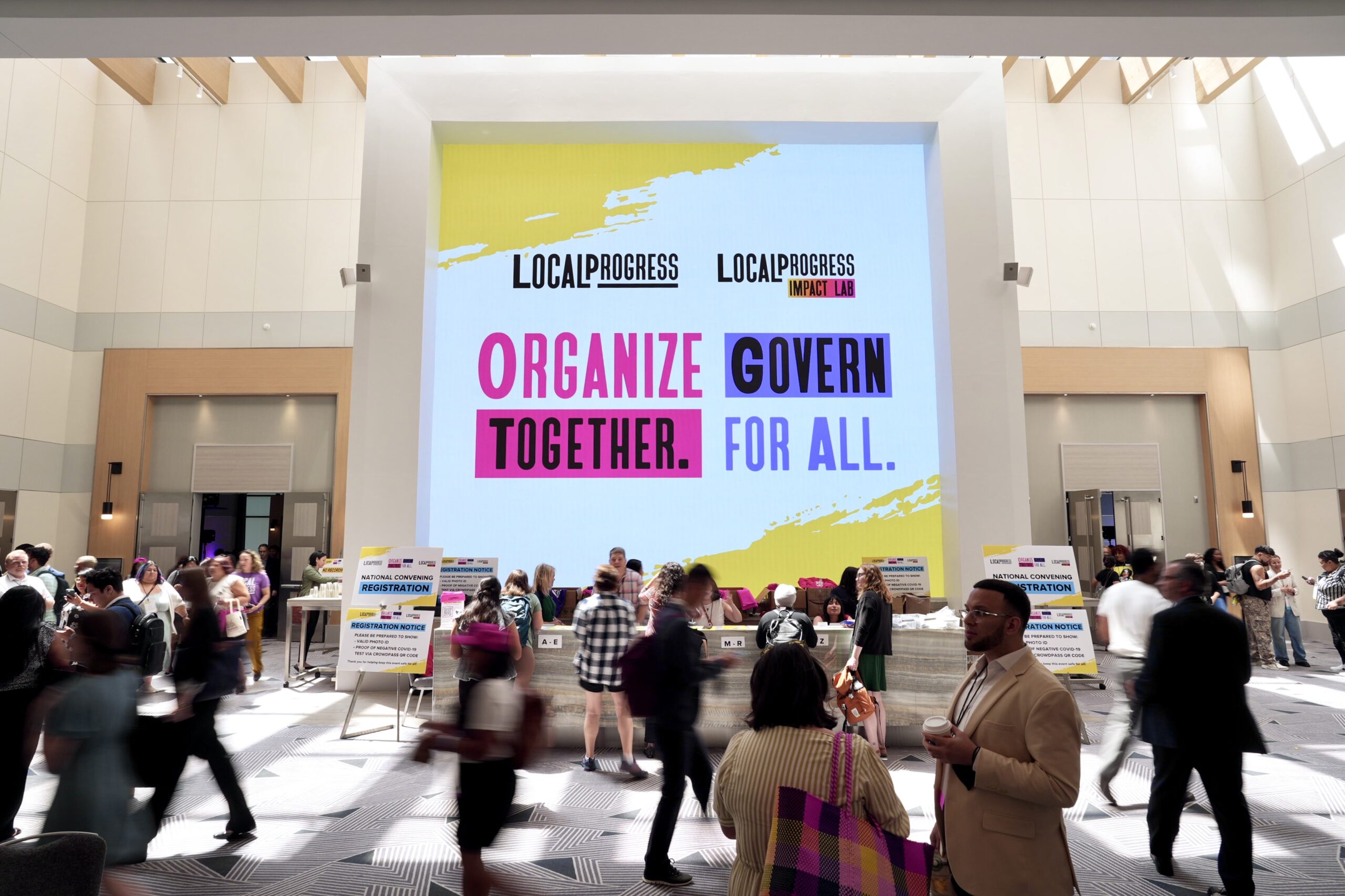 A picture of a big sign that says "Organize Together, Govern for all"
