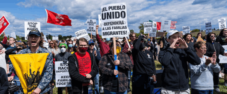 Protesters holding signs at a rally.