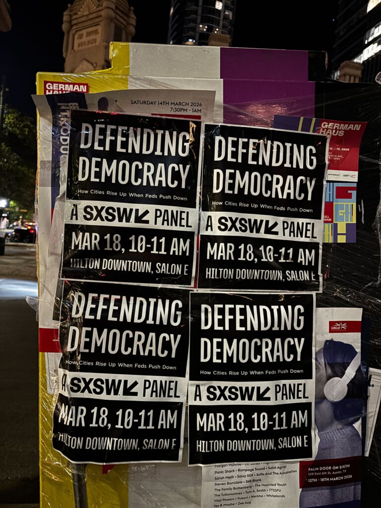 Signs for a "Defending Democracy" panel