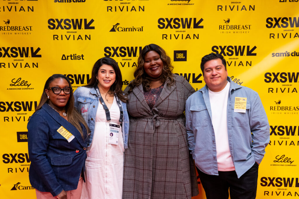 A group of four people posing for a picture