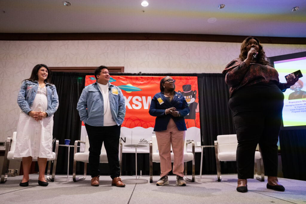 Four people standing and chanting