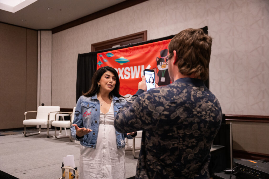 A picture of someone taking a video of someone else