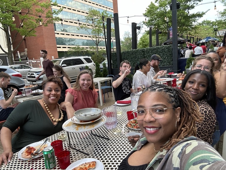 people posing for a selfie at a dinner table