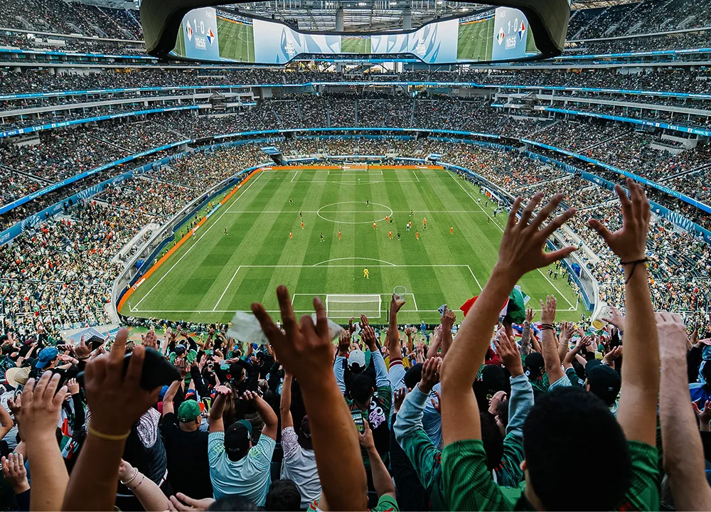 People watching a soccer game in a big stadium
