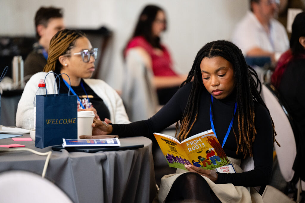 People sitting at a table taking notes
